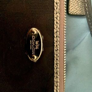 Coach mini purse, small but have enough room to fit a phone and small items.